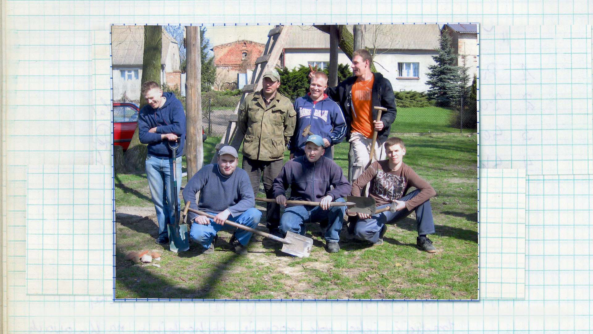 Członkowie Stowarzyszenia Klubu Kawalerskiego obok gotowej trybuny, 2009 Fotografia kolorowa. Siedmiu mężczyzn w różnym wieku pozuje do zdjęcia przy drewnianej konstrukcji. Większość z nich w swoich dłoniach trzyma łopatę, towarzyszymy im radosny nastrój.